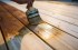 Investor applying varnish to deck